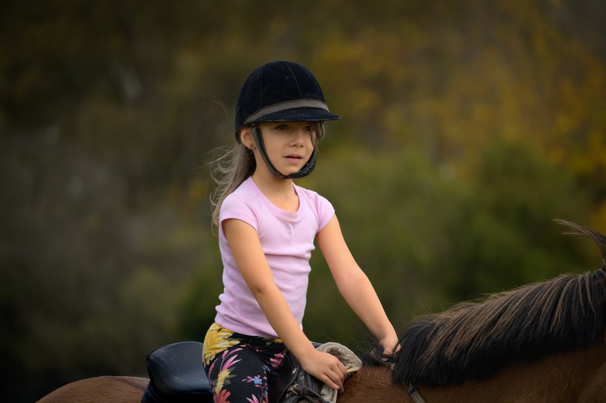 A rider with a calm horse during a lesson at All Out Horsemanship